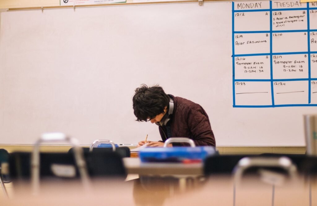 man writing on table